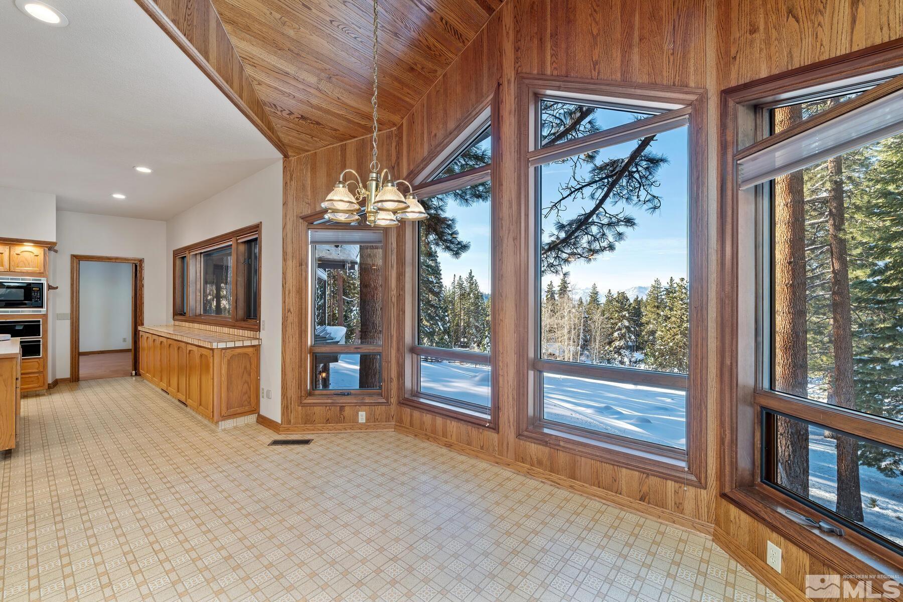 202 Pine Tree Lane Glenbrook, NV 89413 - Photo 15 of 40 a view of an empty room with a fireplace and a window