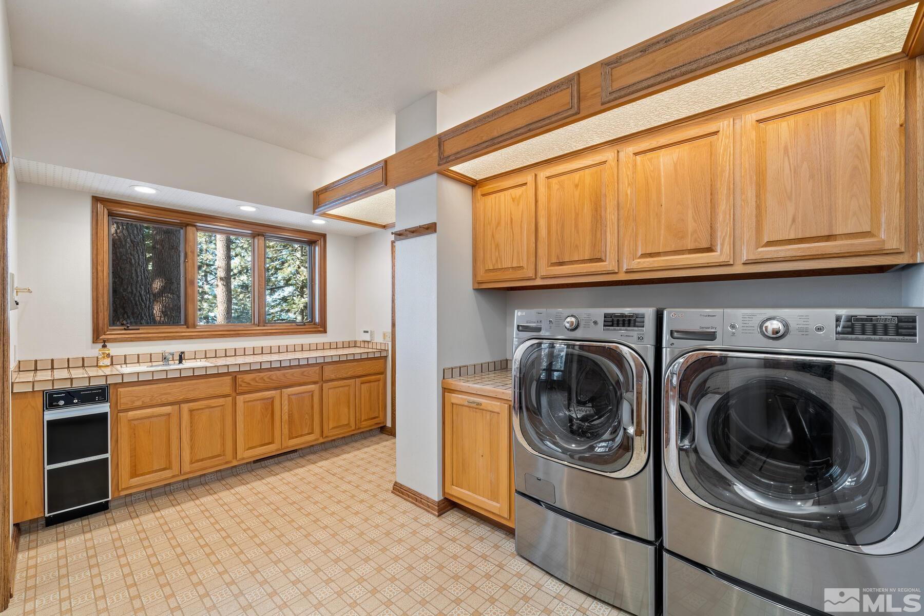202 Pine Tree Lane Glenbrook, NV 89413 - Photo 16 of 40 a kitchen with stainless steel appliances granite countertop a stove and a sink