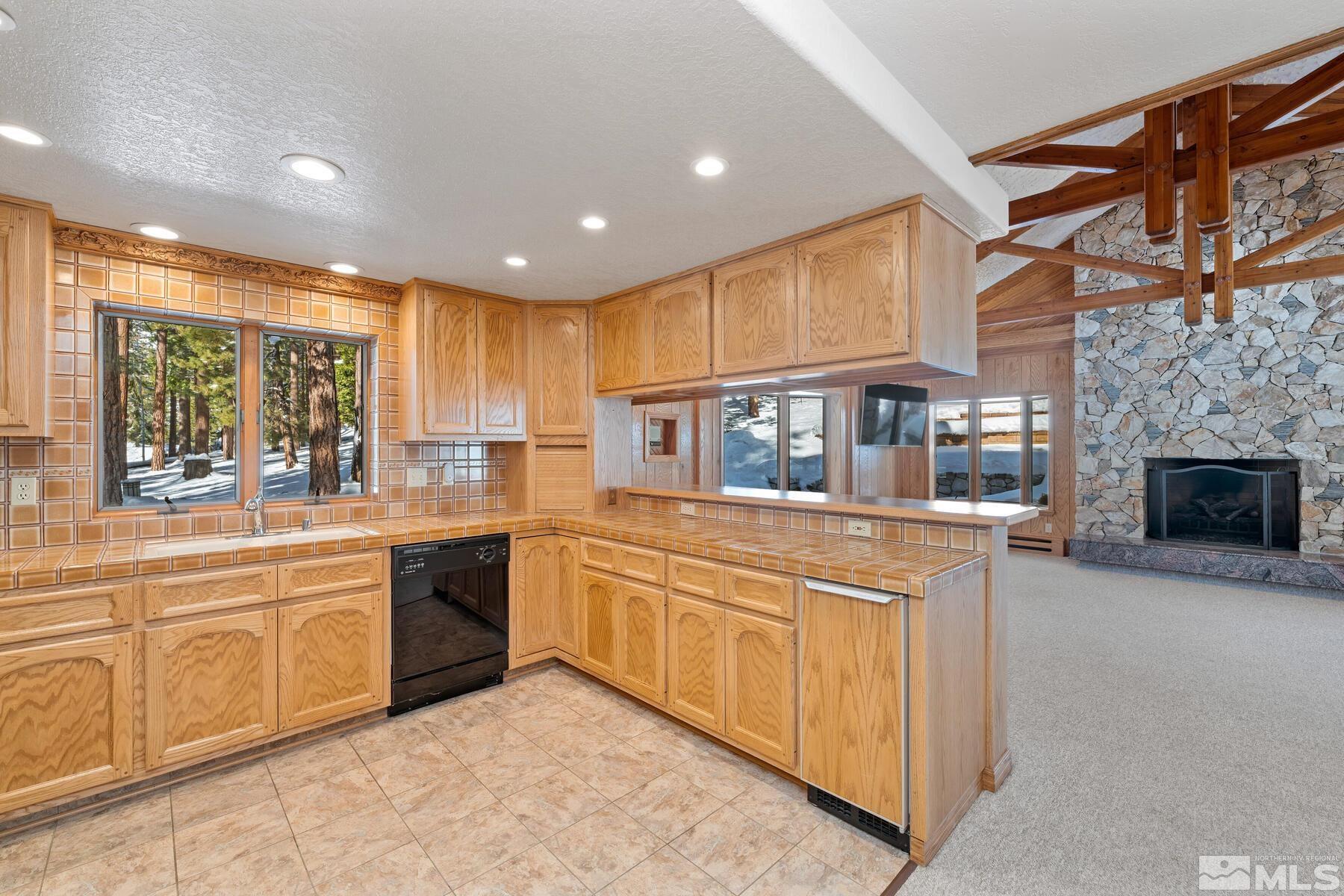 202 Pine Tree Lane Glenbrook, NV 89413 - Photo 17 of 40 a kitchen with stainless steel appliances granite countertop a stove and a sink