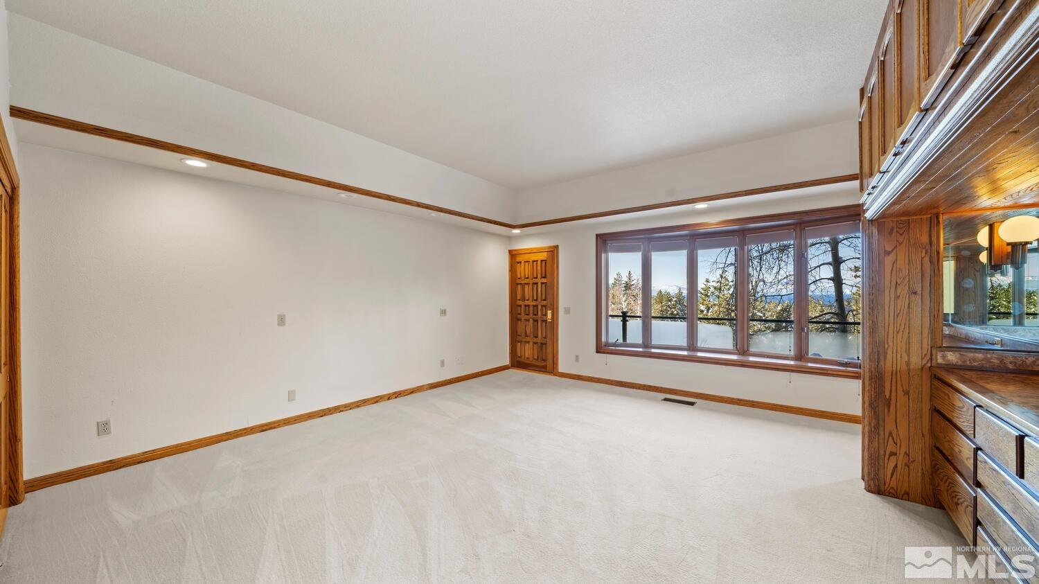202 Pine Tree Lane Glenbrook, NV 89413 - Photo 21 of 40 wooden floor in an empty room with a window