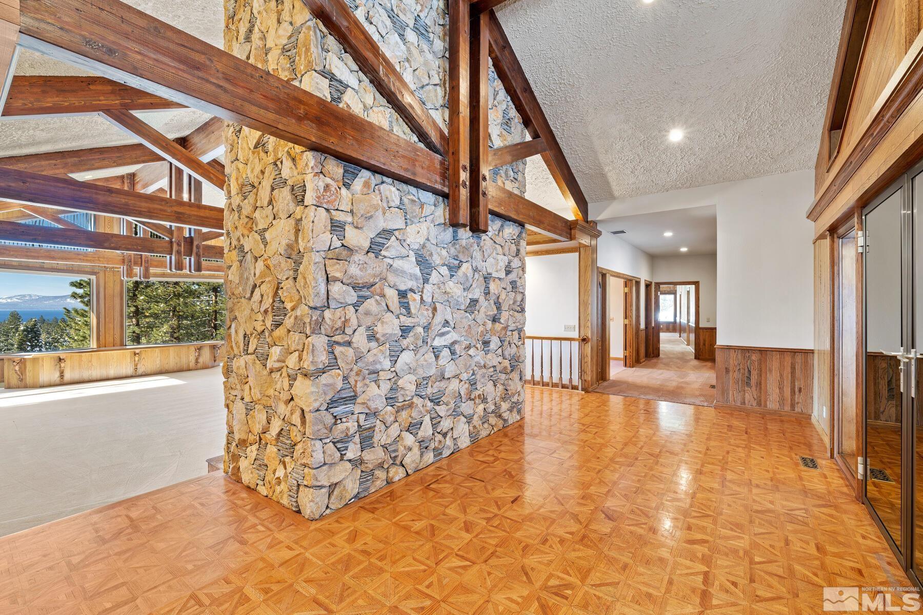 202 Pine Tree Lane Glenbrook, NV 89413 - Photo 8 of 40 a view of empty room with wooden floor and door