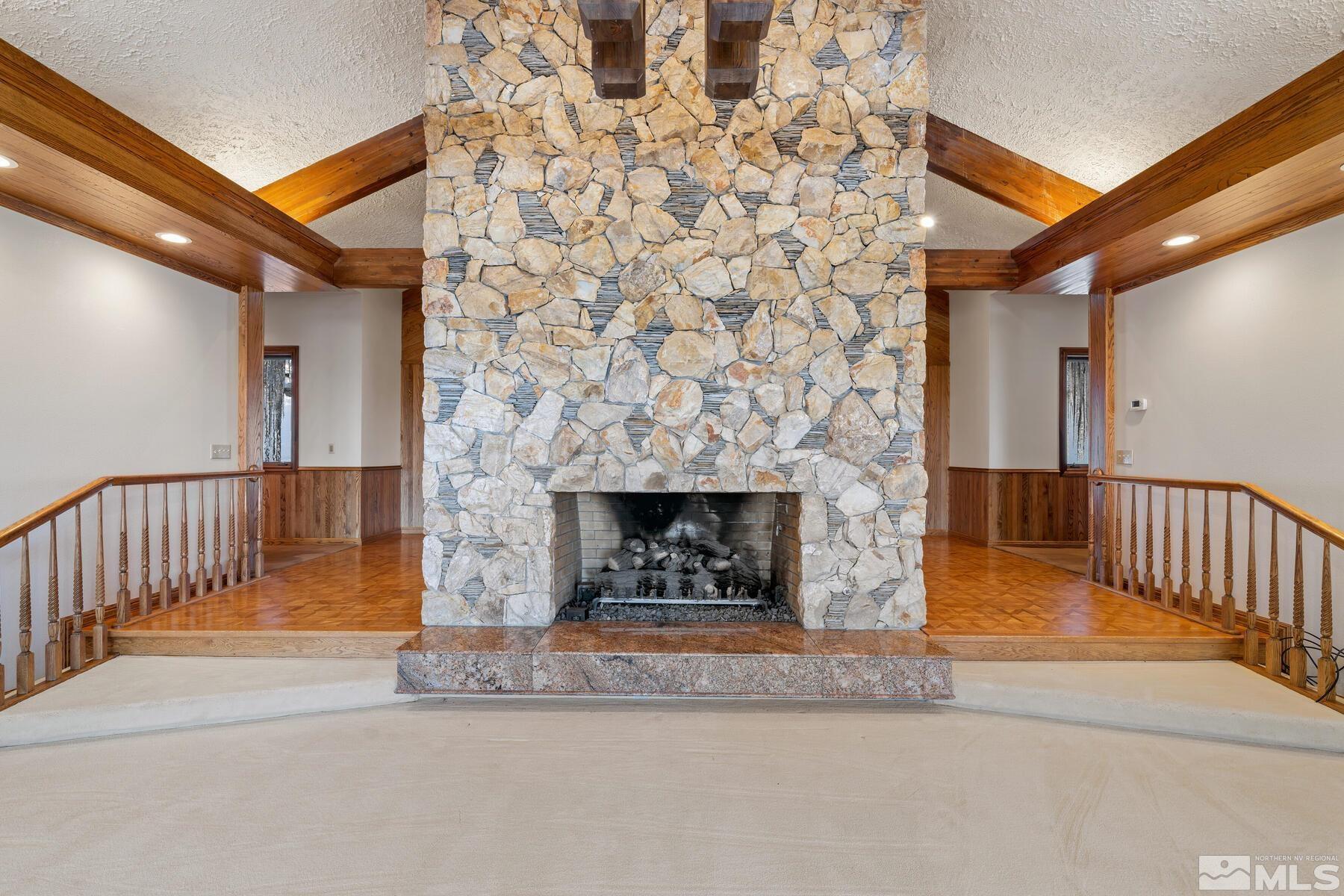 202 Pine Tree Lane Glenbrook, NV 89413 - Photo 9 of 40 a living room with a fireplace and a ceiling fan