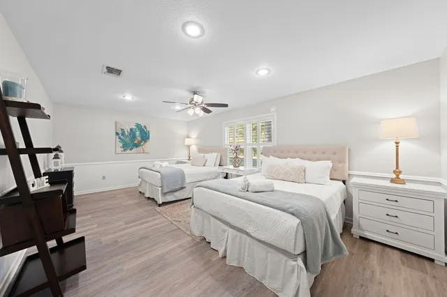 a spacious bedroom with a bed and a couch