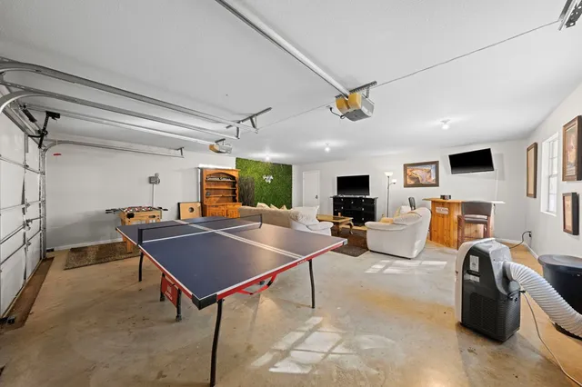 a view of a livingroom with furniture and a flat screen tv