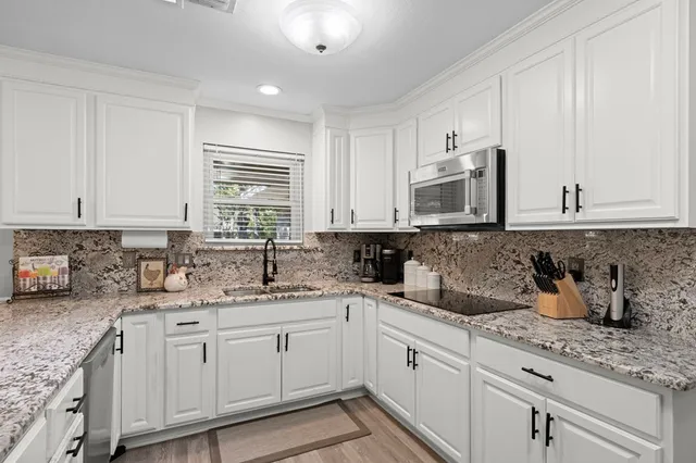 a kitchen with sink and cabinets