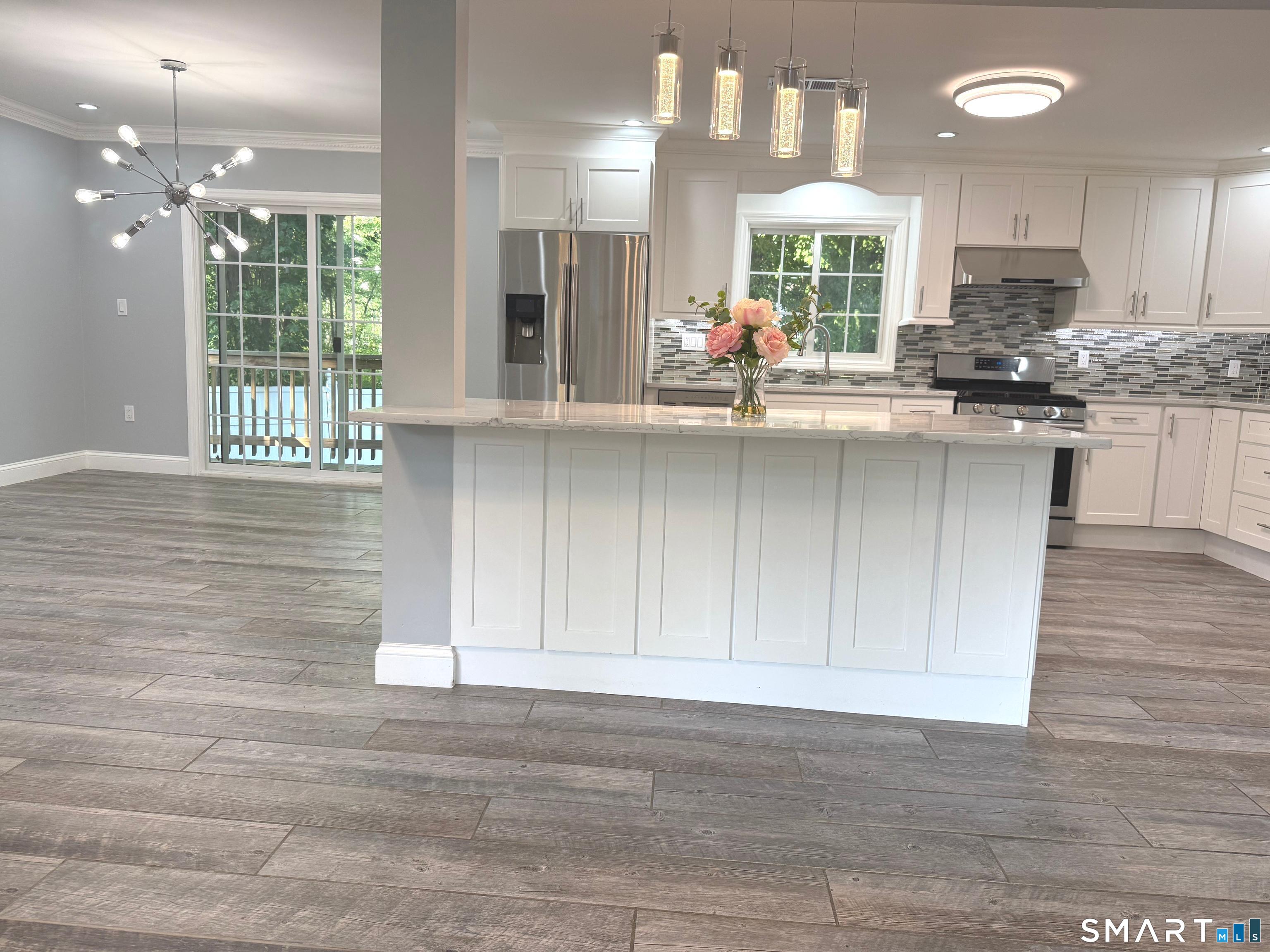 5 Griffith Road Greenwich, CT 06878 - Photo 11 of 34 Stunning chef's kitchen with quartz countertops, a large center island, stainless steel appliances, and abundant cabinetry.