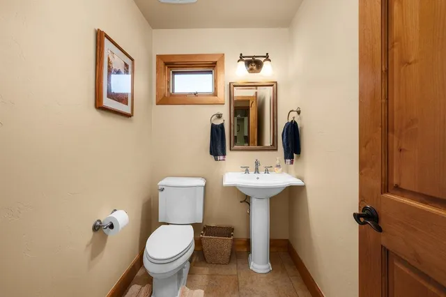 a bathroom with a toilet sink and mirror