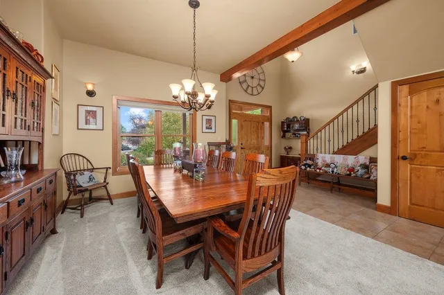 a view of a dining room with furniture and a chandelier