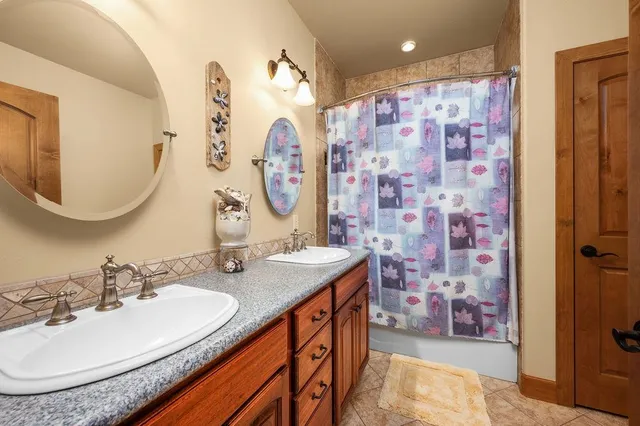 a bathroom with a sink double vanity and a mirror