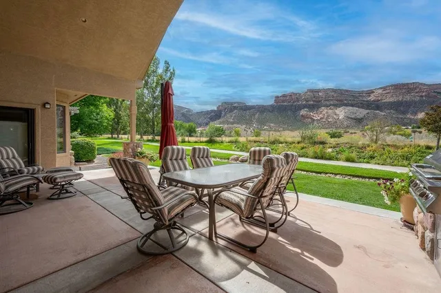 a view of a patio with a table chairs and a table