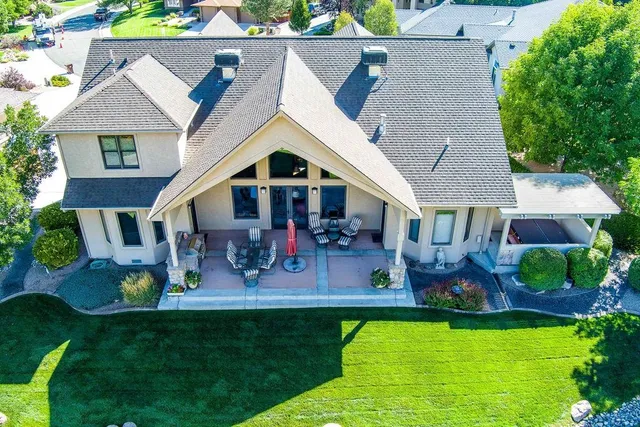 an aerial view of a house with swimming pool garden and patio
