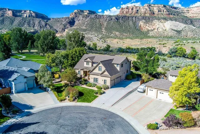 an aerial view of a house with a garden and trees