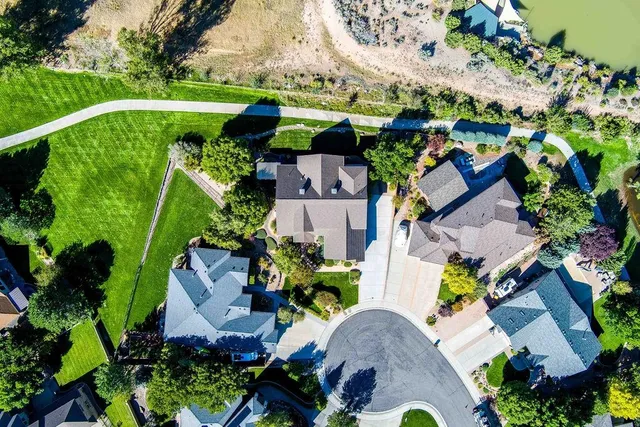 an aerial view of a house with a garden and swimming pool