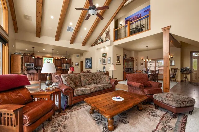 a living room with furniture a rug and a chandelier