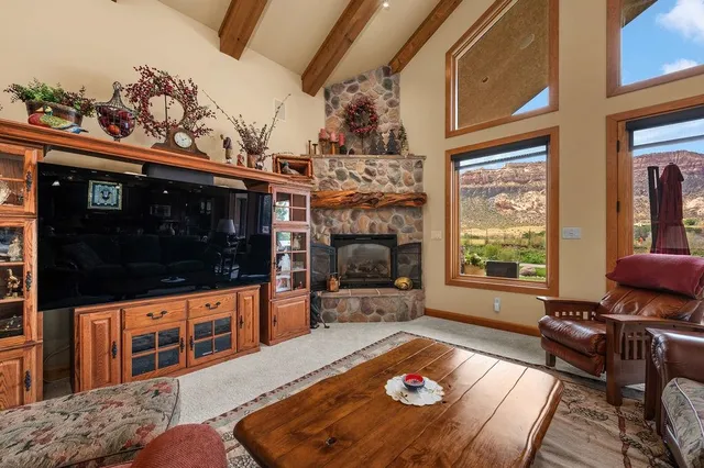 a living room with furniture fireplace and flat screen tv
