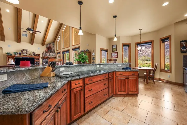 a kitchen with stainless steel appliances granite countertop a stove a sink and a wooden floors