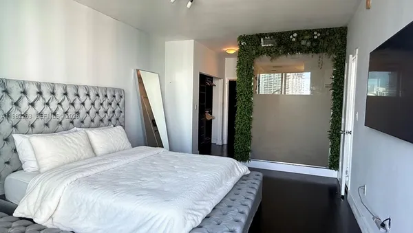 a bedroom with a bed and a mirror