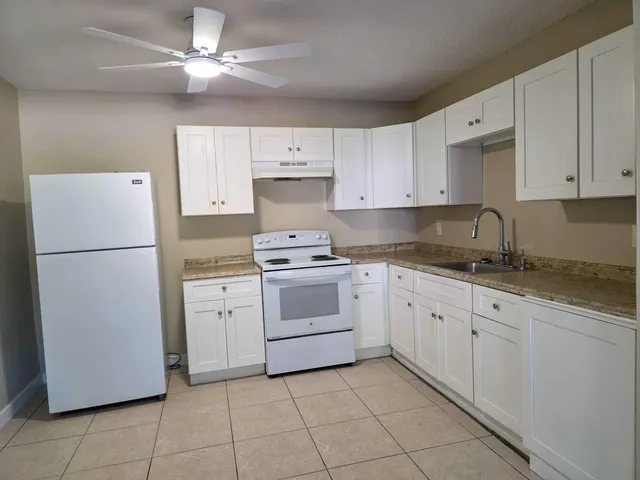 a kitchen with cabinets stainless steel appliances and a counter space
