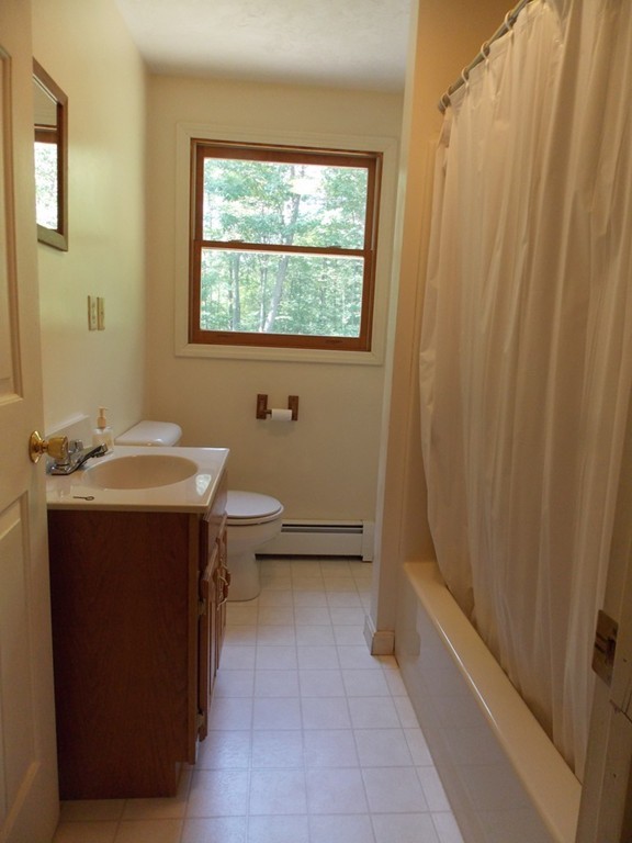 48 Simonds Hill Road Hubbardston, MA 01452 - Photo 23 of 25 a bathroom with a sink a toilet and tub
