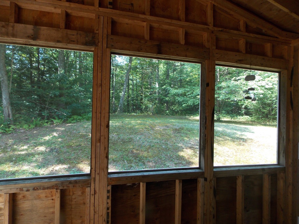 48 Simonds Hill Road Hubbardston, MA 01452 - Photo 5 of 25 a view of a room with large windows and wooden floor