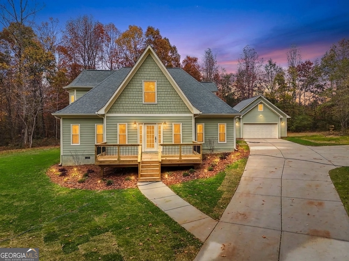 a view of a house with backyard and sitting area