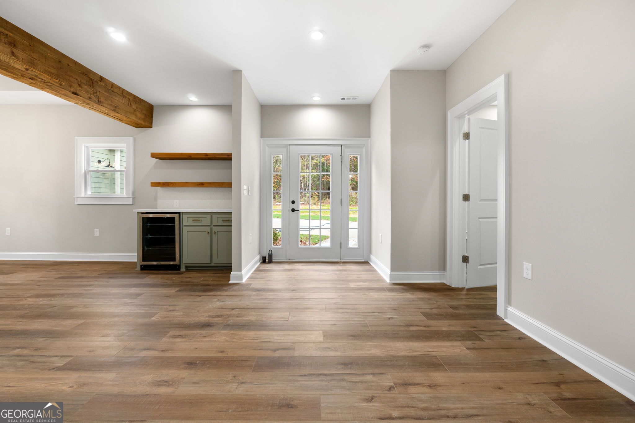 164 I I Walker Brooks Road Newnan, GA 30263 - Photo 16 of 54 an empty room with wooden floor and a fireplace