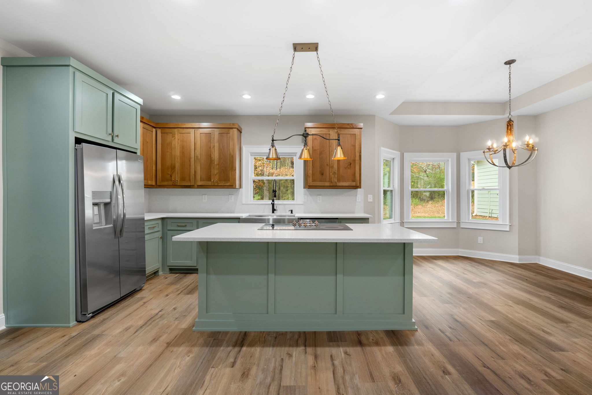 164 I I Walker Brooks Road Newnan, GA 30263 - Photo 21 of 54 a kitchen with kitchen island a counter top space a sink appliances and cabinets