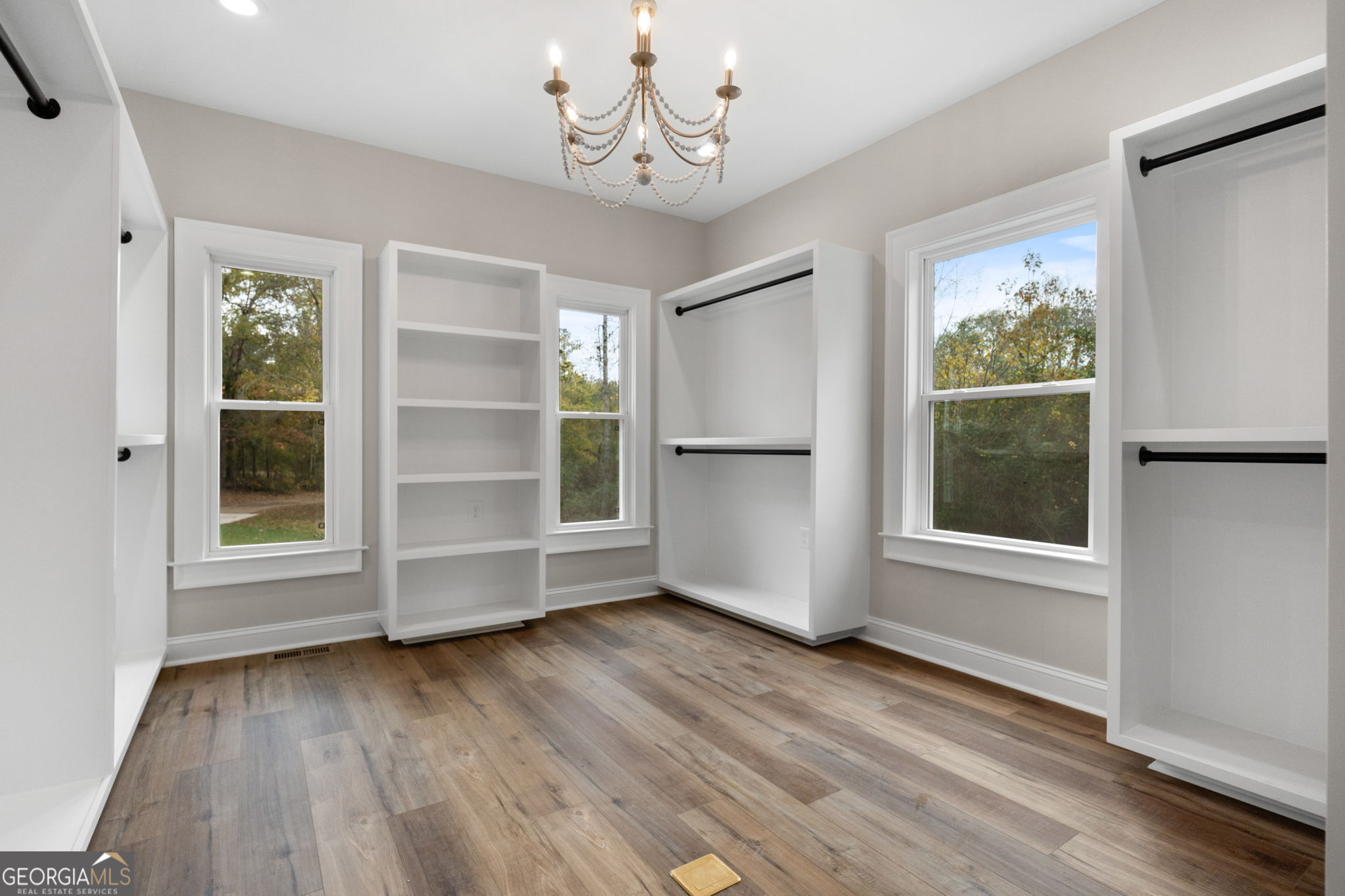 164 I I Walker Brooks Road Newnan, GA 30263 - Photo 33 of 54 an empty room with wooden floor cabinet and windows