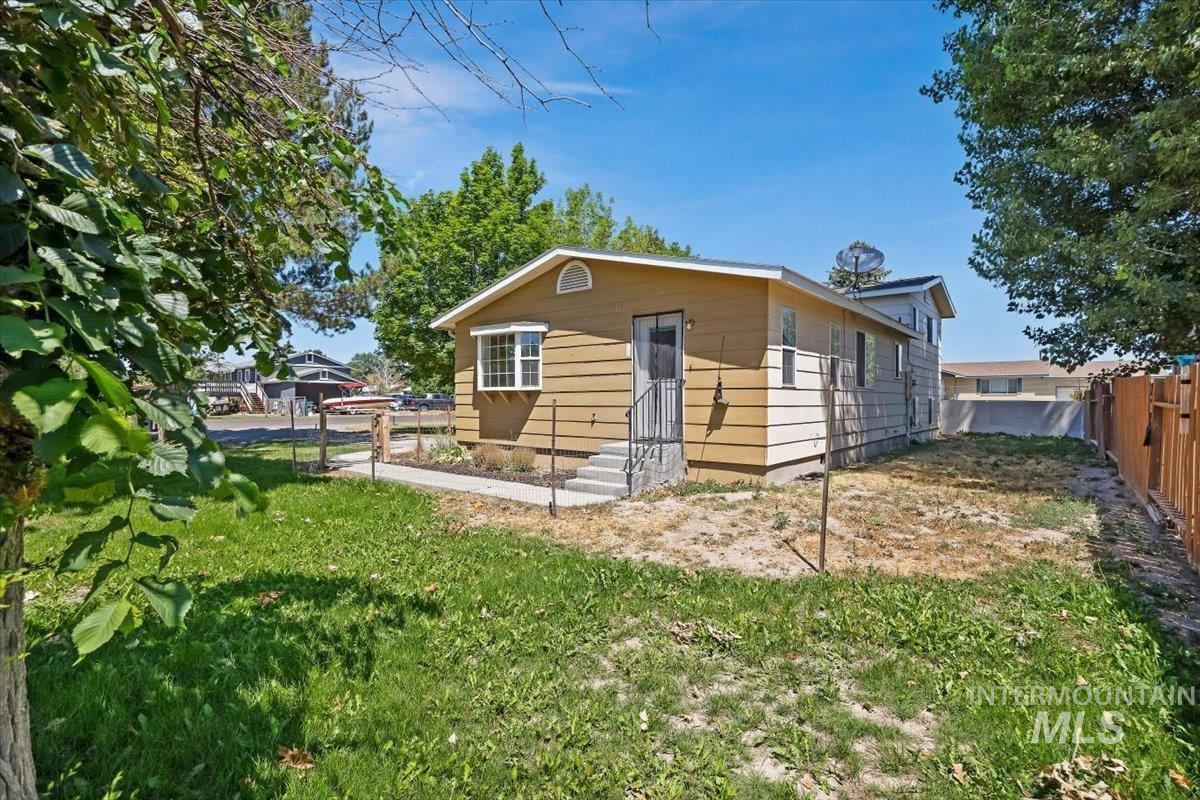 1940 Q Street Heyburn, ID 83336 - Photo 26 of 30 Exterior featuring horizontal siding, a bay window with multiple panes, and an entryway with metal railings