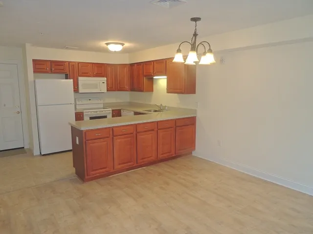 a kitchen with a sink and chandelier