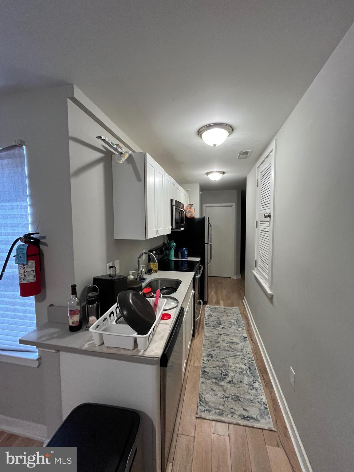 1625 Fontain Street Philadelphia, PA 19121 - Photo 18 of 24 a kitchen that has a lot of cabinets a sink and appliances