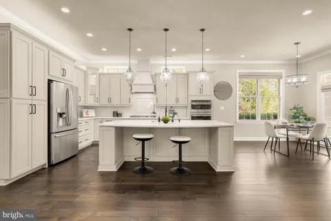 a kitchen with stainless steel appliances kitchen island a refrigerator and a stove