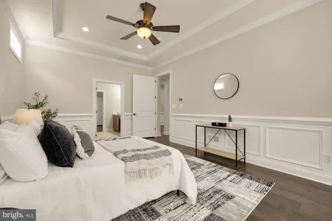 a living room with furniture a flat screen tv and a chandelier