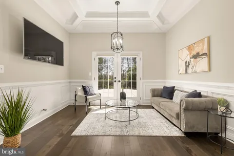 a living room with furniture floor and a flat screen tv
