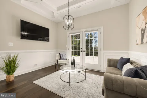 a living room with furniture and a chandelier