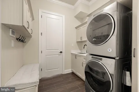 a utility room with sink dryer and washer