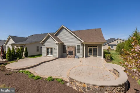 a view of a house with a yard and sitting area