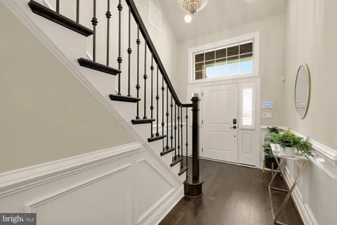 a view of entryway with wooden floor and stairs