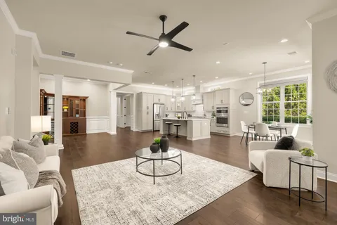 a living room with furniture a rug and a large window