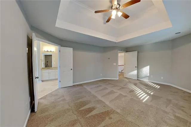 a view of a livingroom with a ceiling fan and window