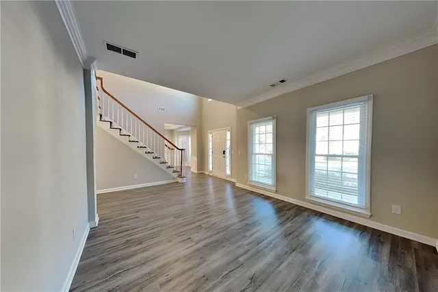 a view of an entryway with wooden floor