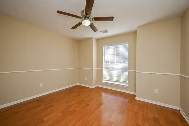 an empty room with a empty space and a ceiling fan
