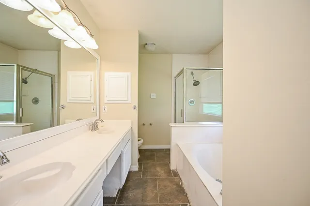 a bathroom with a double vanity sink and mirror with shower