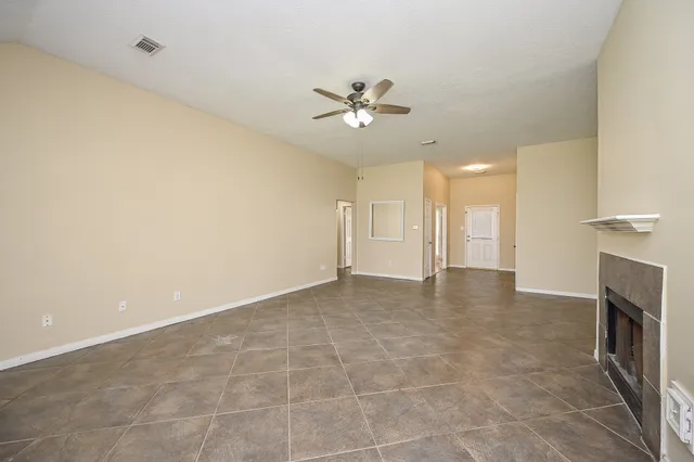 a view of an empty room and fire place