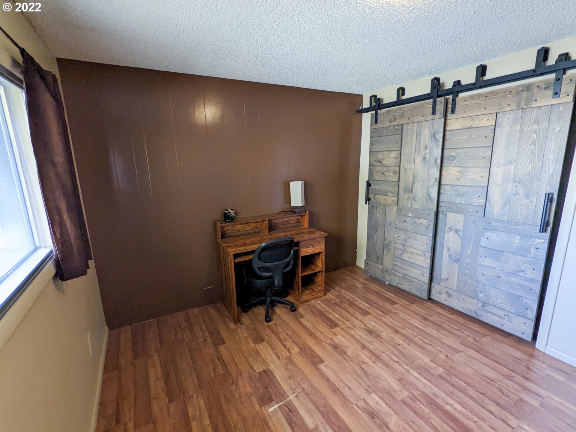 680 Ruckman Avenue Imbler, OR 97841 - Photo 13 of 24 a view of a hallway with wooden floor and furniture