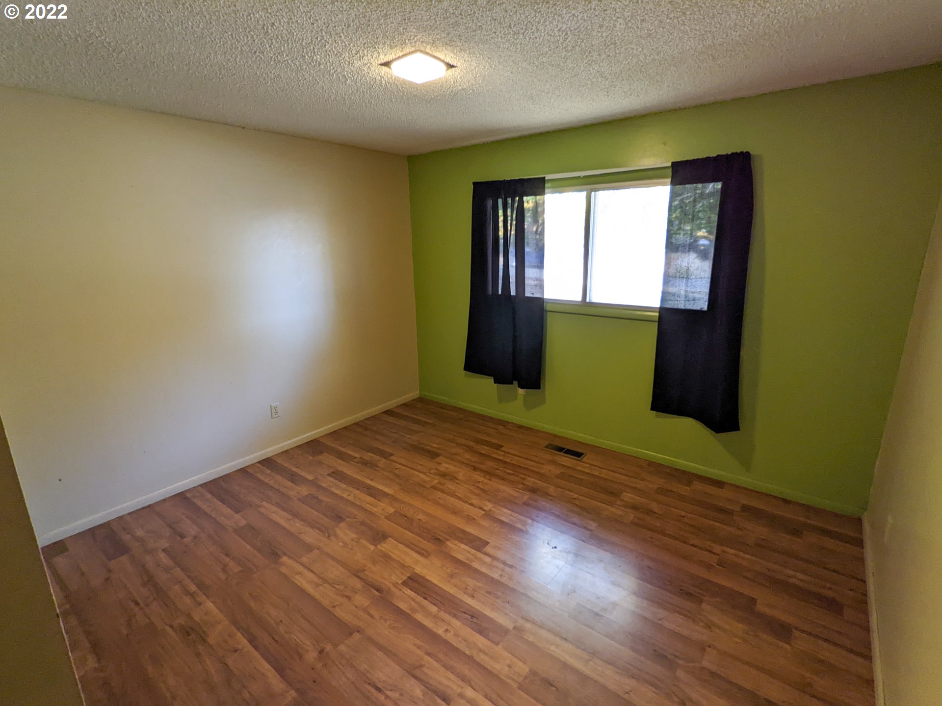 680 Ruckman Avenue Imbler, OR 97841 - Photo 14 of 24 a view of empty room with wooden floor and fan