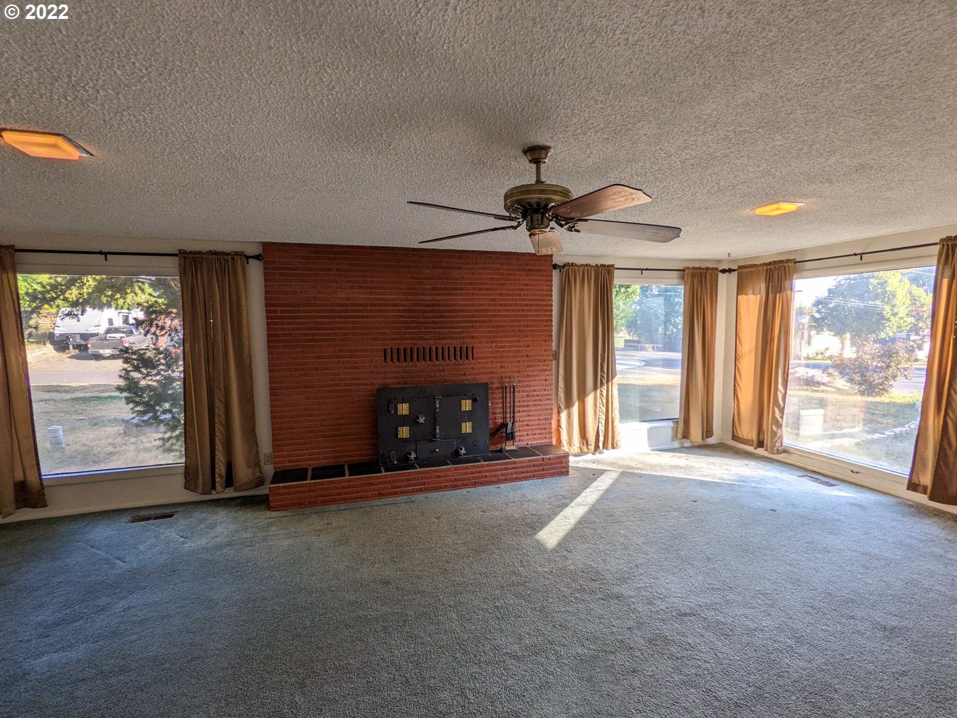 680 Ruckman Avenue Imbler, OR 97841 - Photo 3 of 24 a view of an empty room with windows and a fireplace