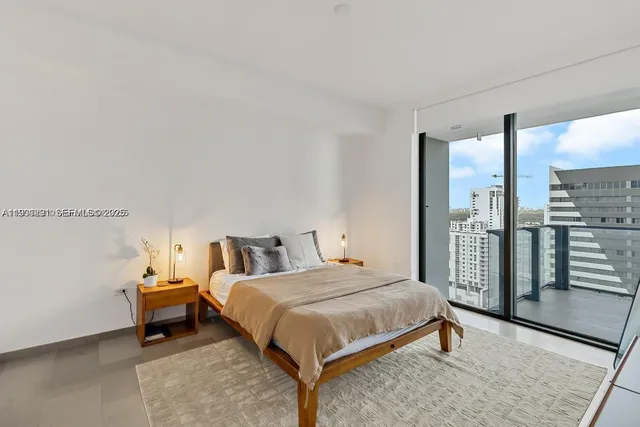 a bedroom with a bed and large mirror