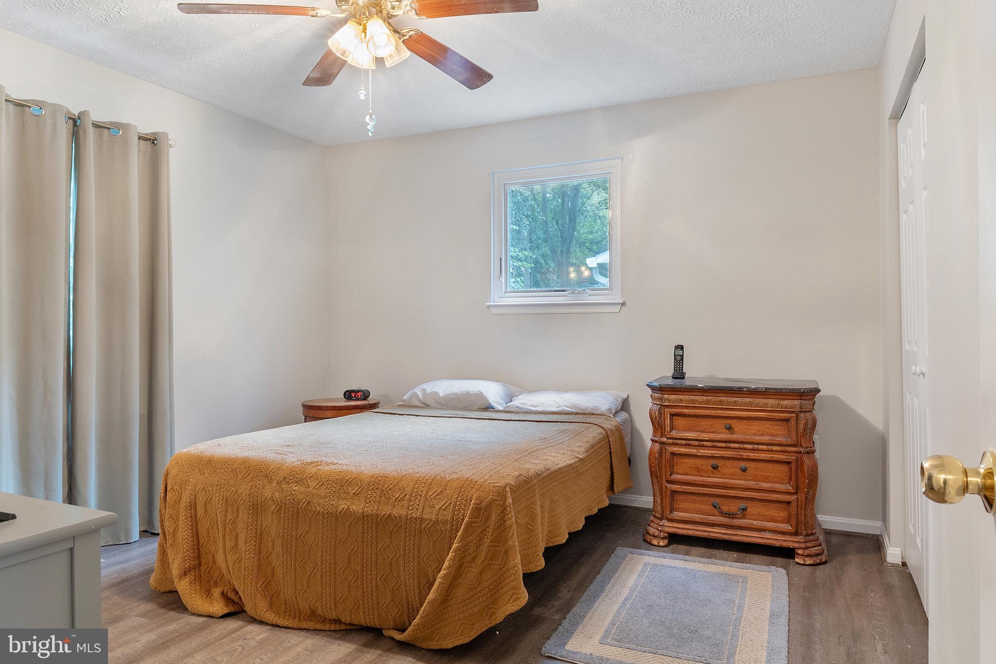 11316 Commanche Road Lusby, MD 20657 - Photo 17 of 68 a bedroom with a bed and a dresser