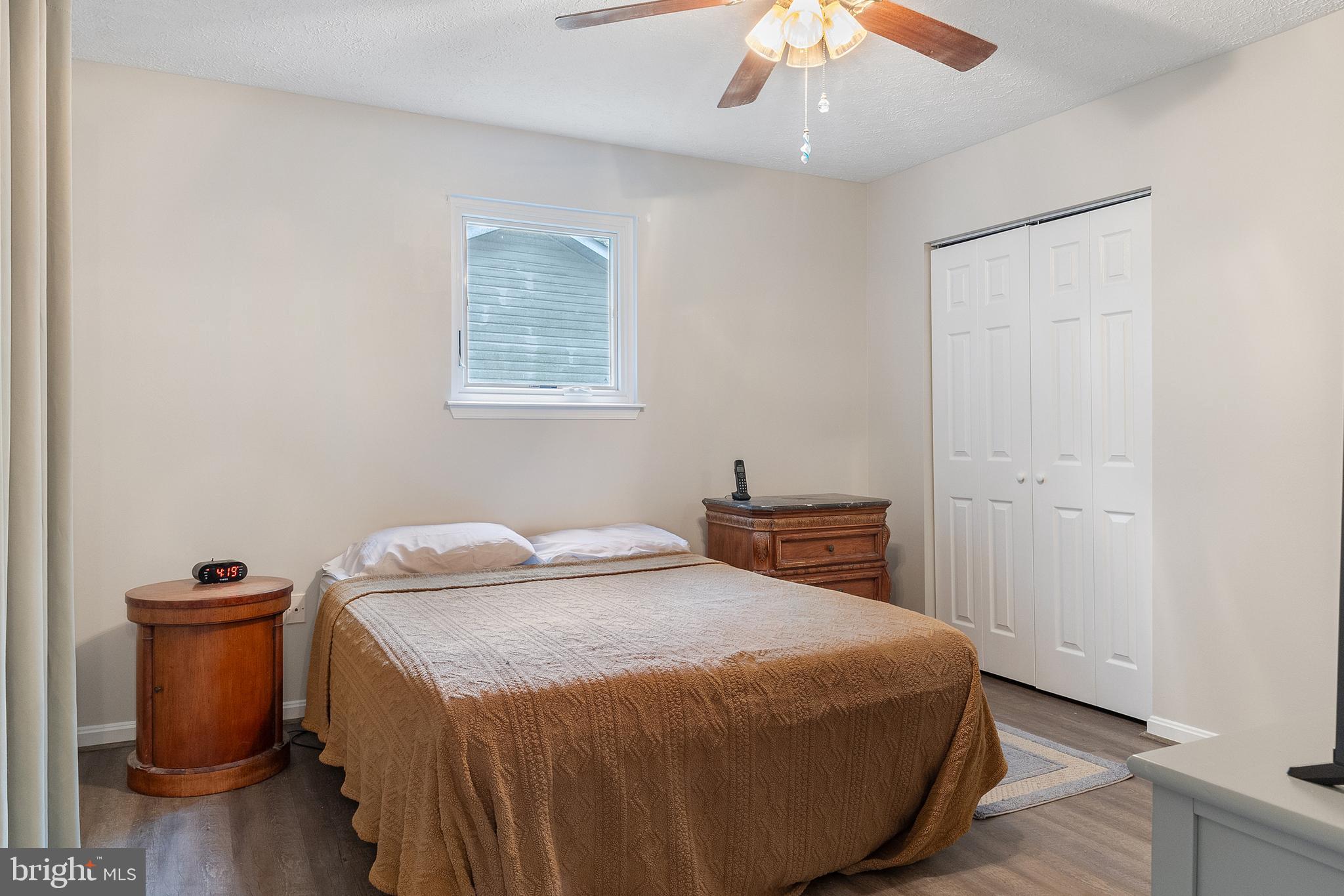 11316 Commanche Road Lusby, MD 20657 - Photo 18 of 68 a bedroom with a bed and a chandelier